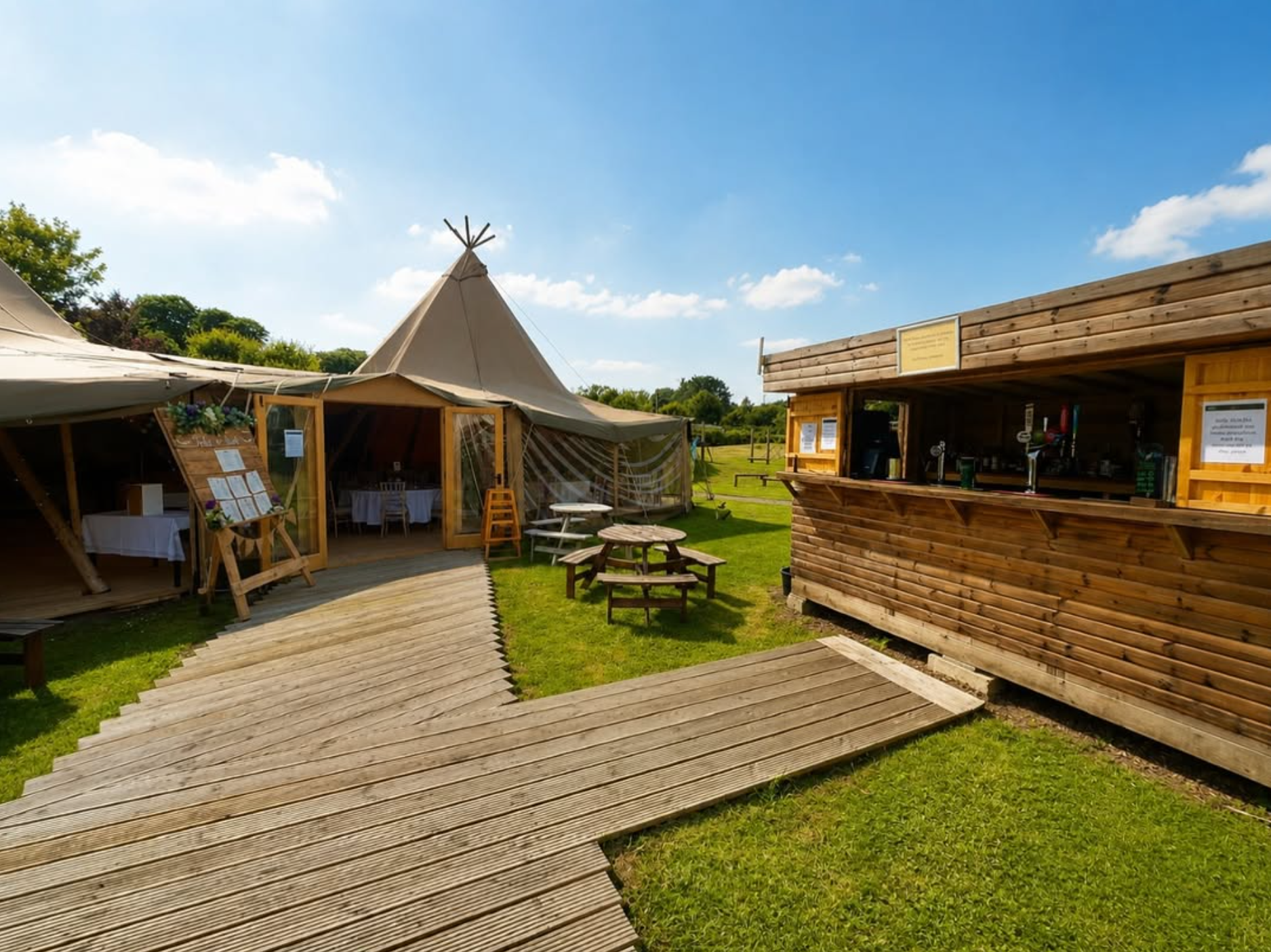 The Calloose wedding Tipi and outdoor bar on a sunny day